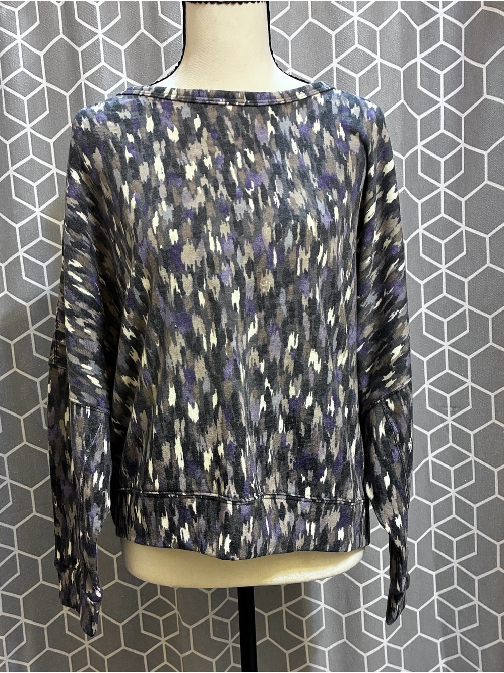 Multi colored sweater with back peek opening.